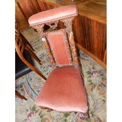 110 - A Victorian walnut framed Prie Dieu chair with pink upholstered seat and back, carved splats, on sho... 