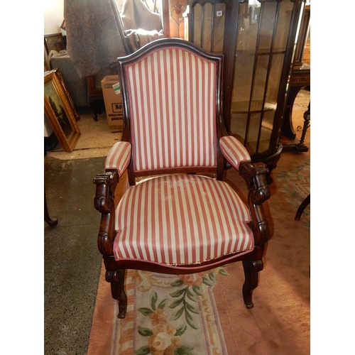 114 - A pair of mahogany framed armchairs with upholstered seats, backs and armpads, scroll arms, on cabri... 