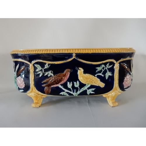 151 - A majolica style jardiniere, blue ground decorated birds and bulrushes - 17in. wide and 8in. high