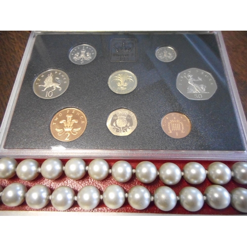 220 - A simulated pearl necklace, two sets of British Coins, a paste set necklace and matching earrings an... 