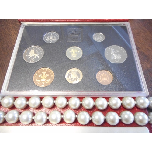 220 - A simulated pearl necklace, two sets of British Coins, a paste set necklace and matching earrings an... 