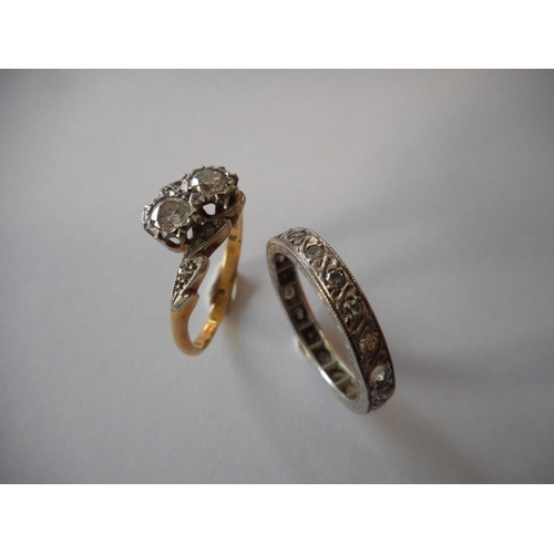 250 - A lady's crossover ring set two diamonds, on an 18ct. gold and platinum shank and a lady's eternity ... 