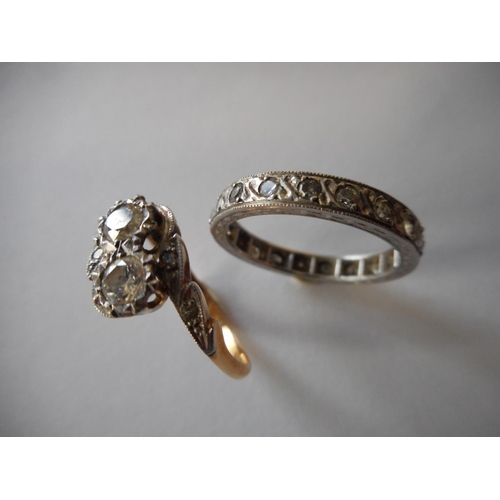 250 - A lady's crossover ring set two diamonds, on an 18ct. gold and platinum shank and a lady's eternity ... 