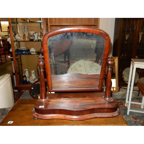 54 - A Victorian mahogany framed swing toilet mirror with turned supports, on shaped base and an iron thr... 