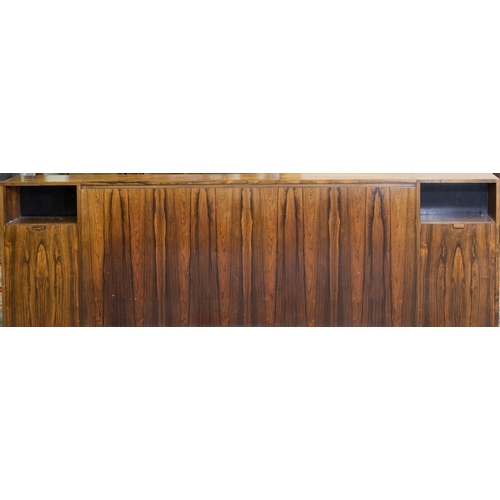 72 - A mid 20th Century Danish rosewood headboard fitted to each end with integrated side cabinets, possi... 