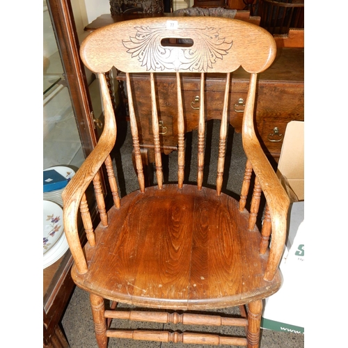 77 - An elm armchair with incised decoration to the cresting rail, turned supports, hard seat, on turned ... 