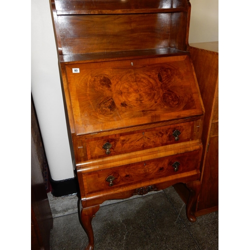 83 - A walnut bureau, the upper part fitted shelf, above hinged fall front enclosing fitted interior, two... 