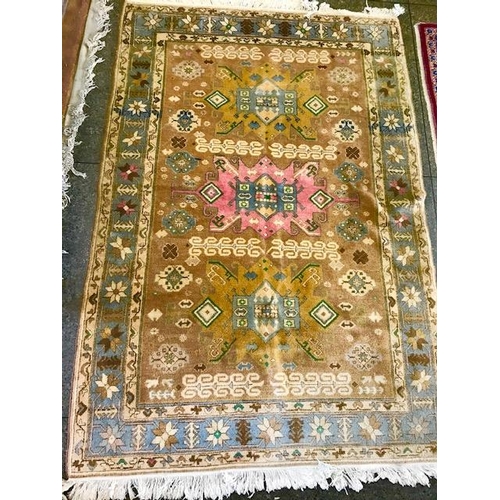 2 - An Eastern rug, beige field with repeating medallion pattern centre in beige, cream, blue and green,... 