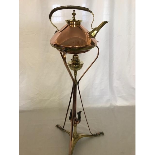 266 - A Benson brass and copper tea kettle with wicker covered handle, on a matching stand with burner, on... 