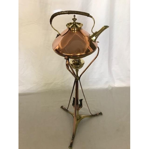 266 - A Benson brass and copper tea kettle with wicker covered handle, on a matching stand with burner, on... 