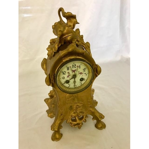 267 - A French mantel clock with white enamel dial painted flowers, striking movement on a bell, in a gold... 