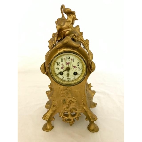 267 - A French mantel clock with white enamel dial painted flowers, striking movement on a bell, in a gold... 