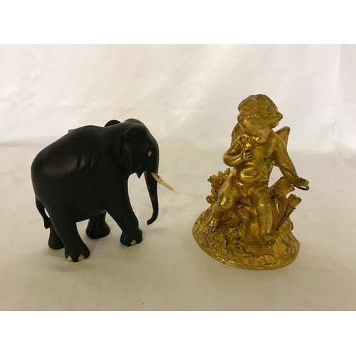 269 - A 19th Century gilded bronze cupid - 6 1/2in. high and an ebony elephant