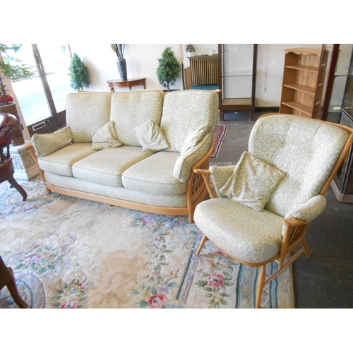 27 - An Ercol Windsor light elm framed  three piece suite comprising:- three settee and two matching armc... 