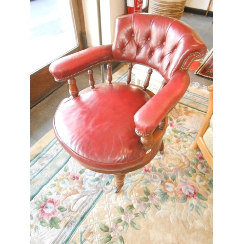 35 - A Victorian walnut framed tub chair with upholstered cresting rail and seat in buttoned red leather,... 