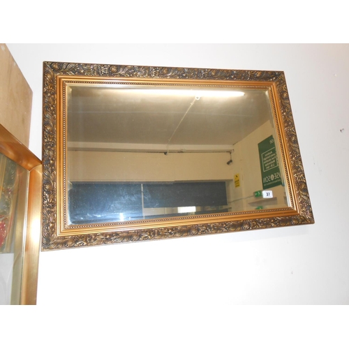 37 - A modern rectangular bevelled wall mirror in a decorative gilt frame