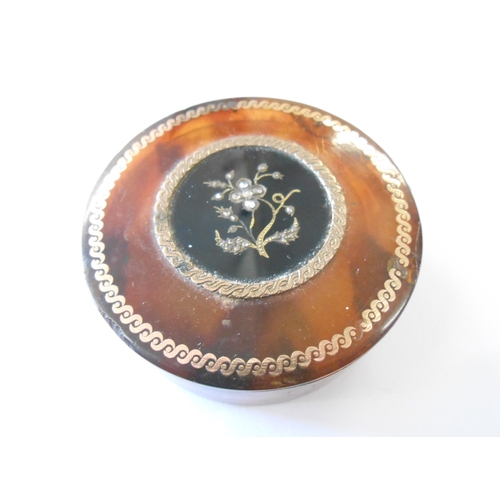 255 - A Georgian tortoiseshell snuff box, the lid inset gold and diamonds to floral design - 2 1/4in. dia.... 