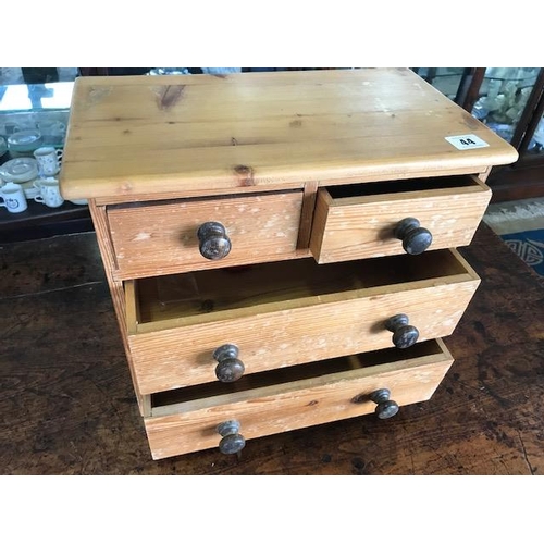 44 - A miniature pine chest fitted four drawers with turned wood knob handles, on bracket feet - 14in. wi... 