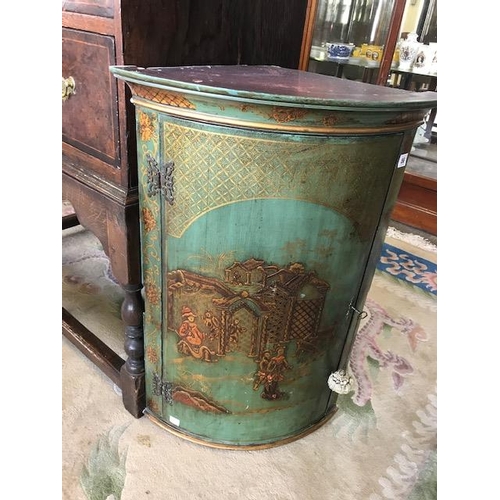 56 - A small green Chinoiserie lacquered wall hanging angle cabinet with bow front decorated figures and ... 