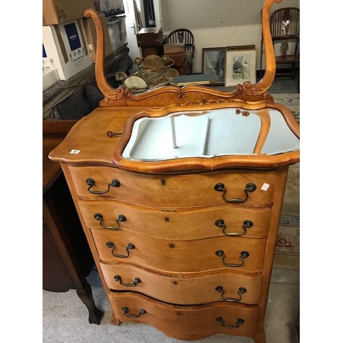 57 - A walnut finished dressing chest fitted oval bevelled mirror above five drawers with serpentine fron... 