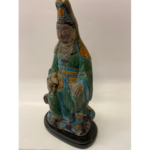 162 - A large pottery model of Quan Yin in blue and green glaze