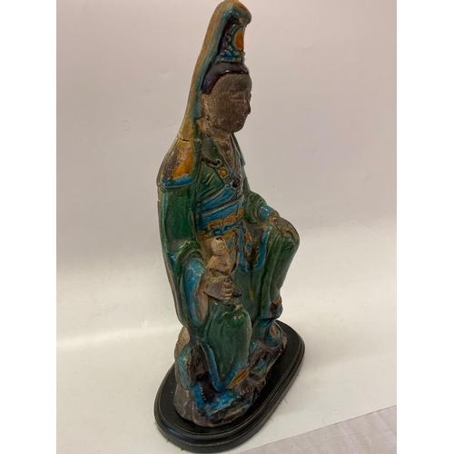 162 - A large pottery model of Quan Yin in blue and green glaze