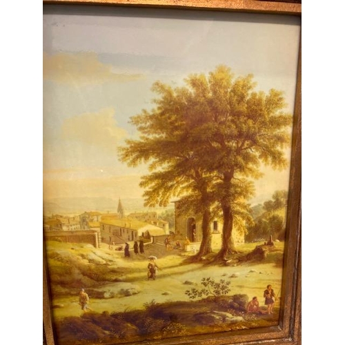 165 - A porcelain panel depicting a Continental landscape with figures, buildings and trees, in a gilt lea... 