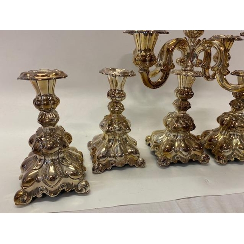 182 - A set of four Continental silver plated candlesticks with lobed decoration, outset leaf style feet a... 