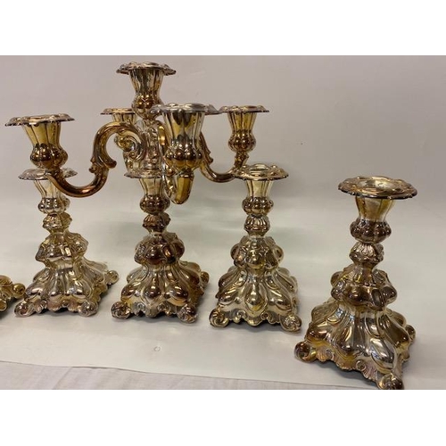 182 - A set of four Continental silver plated candlesticks with lobed decoration, outset leaf style feet a... 