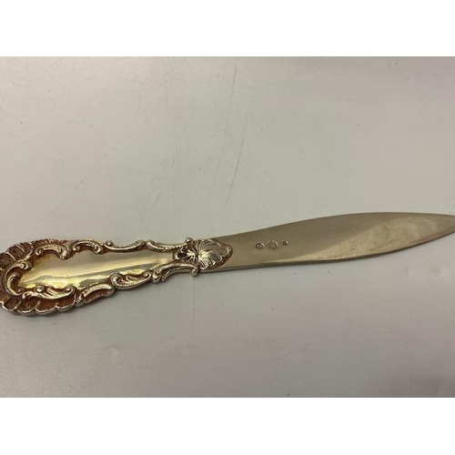 184 - A Danish silver coloured metal letter opener by Johannes Siggaard with leaf scroll handle