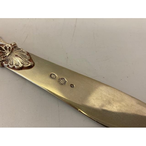 184 - A Danish silver coloured metal letter opener by Johannes Siggaard with leaf scroll handle