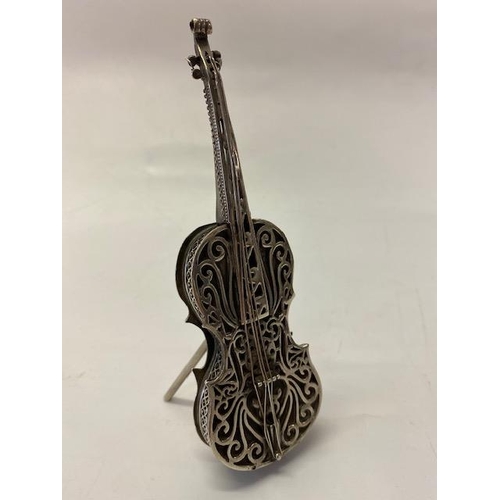 186 - A silver coloured metal vesta case in the form of a cello with scroll decoration, on stand - 5 1/4in... 