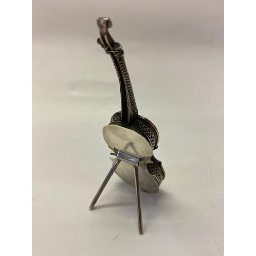 186 - A silver coloured metal vesta case in the form of a cello with scroll decoration, on stand - 5 1/4in... 