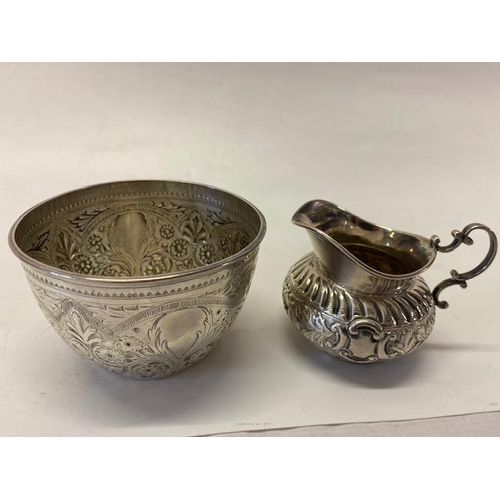 189 - A Victorian silver bowl decorated all round with flowers and leaf scrolls - London 1885, makers mark... 