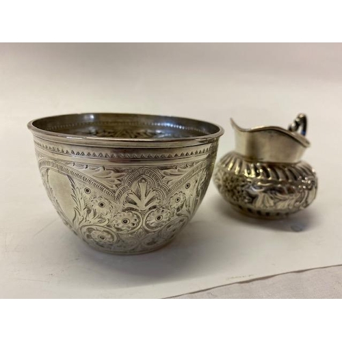 189 - A Victorian silver bowl decorated all round with flowers and leaf scrolls - London 1885, makers mark... 