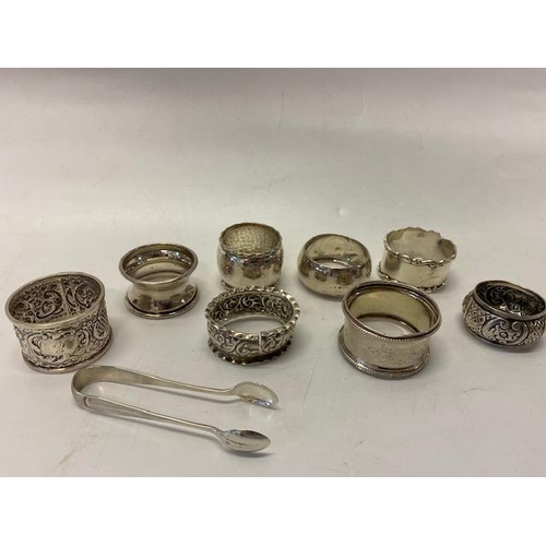 191 - Five silver napkin rings various, three other silver coloured metal napkin rings and a pair of silve... 