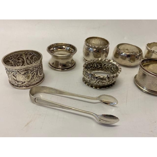 191 - Five silver napkin rings various, three other silver coloured metal napkin rings and a pair of silve... 