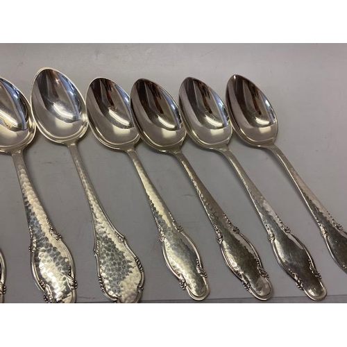 196 - Nine Danish silver tablespoons with hammered and shaped handles, various makers