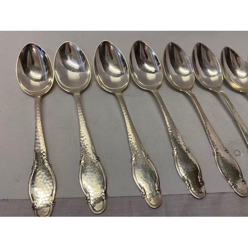 197 - Nine Danish silver dessert spoons with hammered and shaped handles, various makers