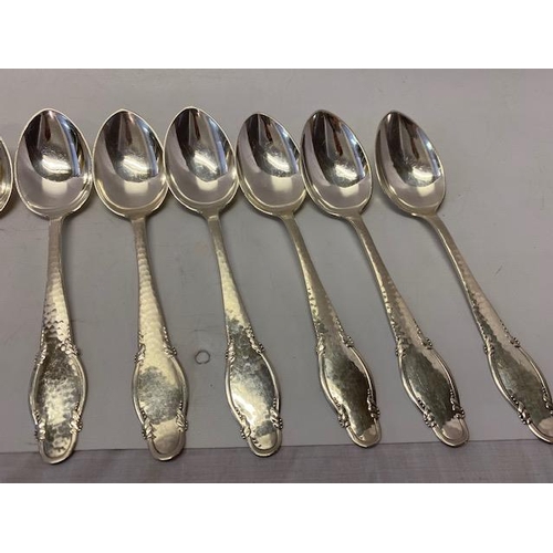 197 - Nine Danish silver dessert spoons with hammered and shaped handles, various makers