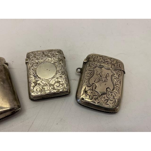 207 - Two silver vesta cases with engraved leaf scroll decoration and one other with inscription to the fr... 