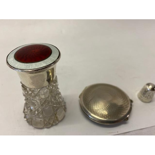 211 - An engine turned silver compact, a cut scent bottle with silver lid inset enamel lid and a silver th... 