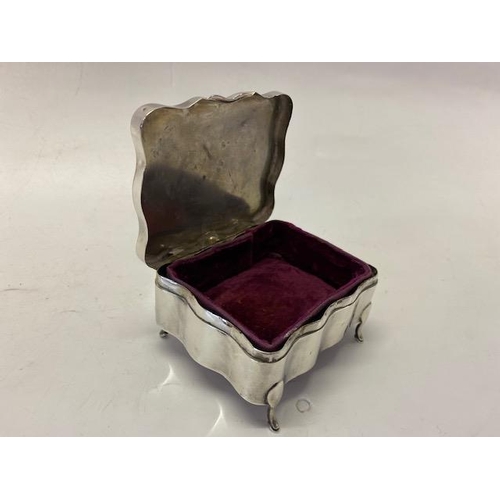 229 - A rectangular silver trinket box with inset circular engine turned decoration, on four short feet -