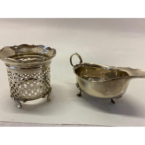 233 - A silver sauce boat with scroll handle, on three pad feet - Birmingham 1911 and a silver bottle fram... 