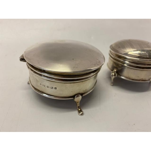 242 - A plain silver circular trinket box, on three pad feet -  and a smaller ditto with engine turned led... 