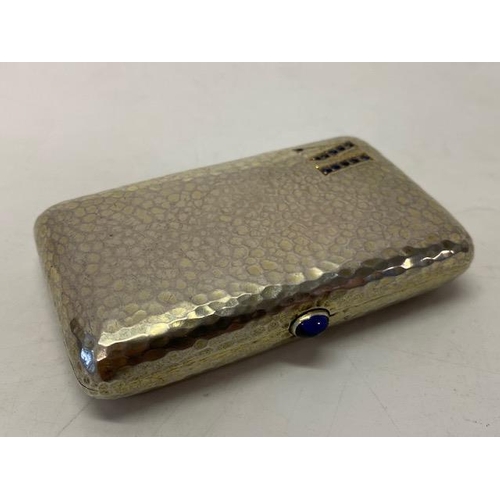 243 - A Continental hammered silver cigarette case, the front with initial M set in sapphires, the reverse... 