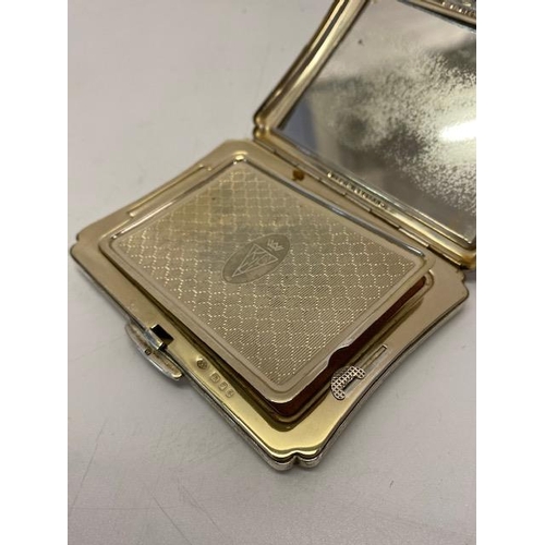 244 - A lady's silver compact with engine turned and engraved flower and leaf scroll decoration