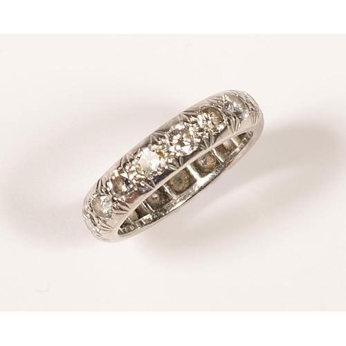 257 - A lady's diamond set full eternity ring mounted in white metal