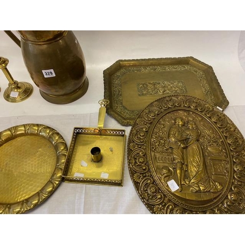 329 - A large brass jug, brass chamberstick, candlesticks etc..