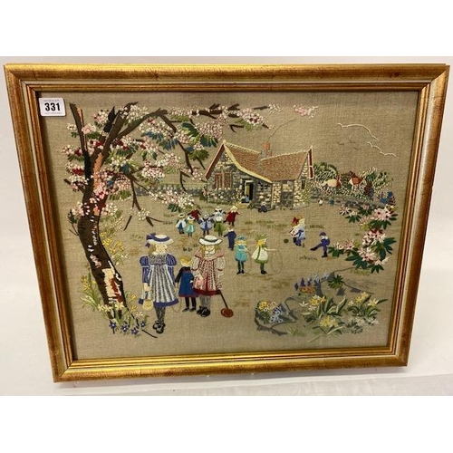 331 - An embroidered panel depicting children in Edwardian dress, playing in a garden, framed and glazed -... 